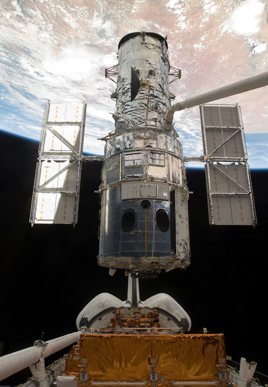 May 19, 2009 - The Space Shuttle Atlantis' remote manipulator system arm lifts the Hubble Space Tele...