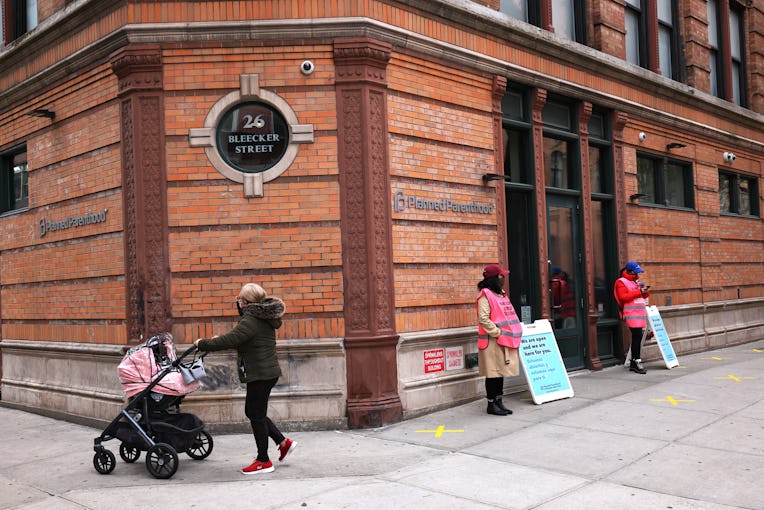 NEW YORK, NEW YORK - APRIL 16: A woman pushes a stroller past the Planned Parenthood in the Financia...