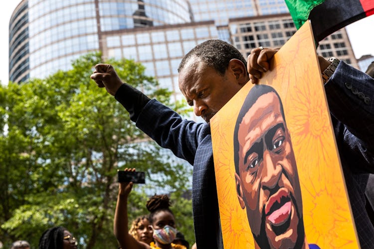 People react after learning the sentencing of former Minneapolis Police officer Derek Chauvin outsid...