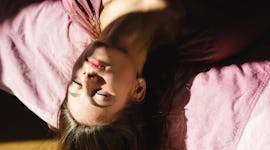 young woman hanging upside down with eyes closed reflects on the emotional meaning of the january 20...