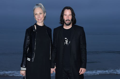 Keanu Reeves and US artist Alexandra Grant arrive for the Saint Laurent Men's Spring-Summer 2020 run...