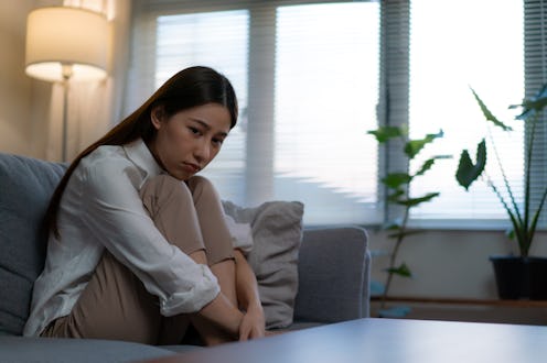 woman looking sad in her living room
