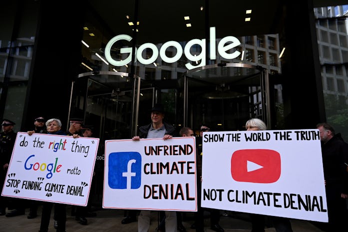 Climate activists hold placards as they protest outside Google offices during the tenth day of demon...