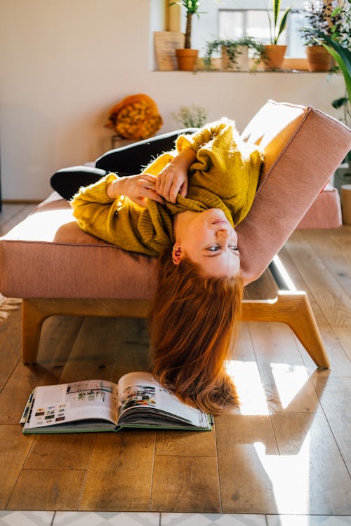 A woman lies upside down on the couch. The December 2021 cold moon will affect these zodiac signs th...