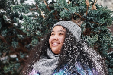 A happy woman in the snow would want to use some ice puns for Instagram. 