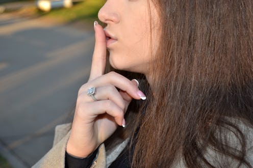 woman shushing her mouth