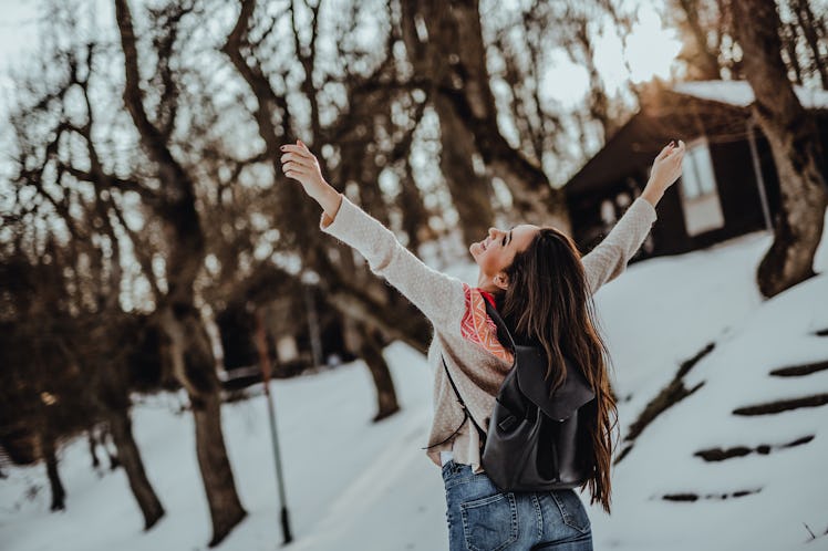 Young woman walking trough the forest