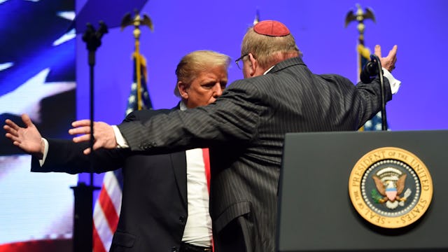 US President Donald Trump hugs Rabbi Benjamin Sendrow after Sendrow prays at the 91st Annual Future ...