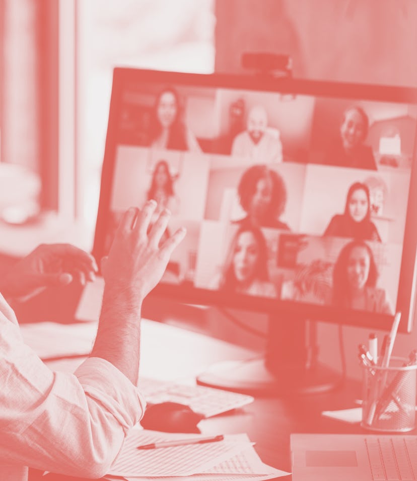 An unrecognizable mid adult businessman gestures during a virtual meeting with the company's multi-e...