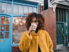 Portrait of a young adult beautiful woman drinking coffee, for which she'll need coffee quotes for I...