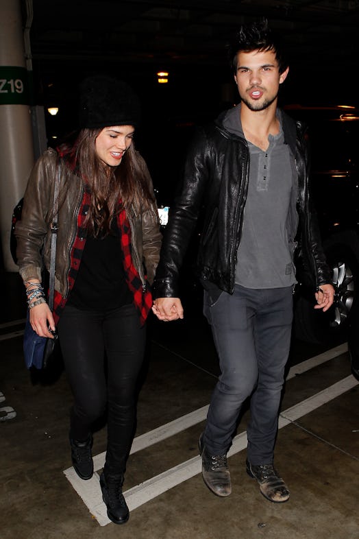 LOS ANGELES, CA - DECEMBER 09:  Taylor Lautner and Marie Avgeropoulos are seen arriving at Staples C...