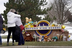 OXFORD, MICHIGAN - DECEMBER 01: People embrace as they visit a makeshift memorial outside of Oxford ...