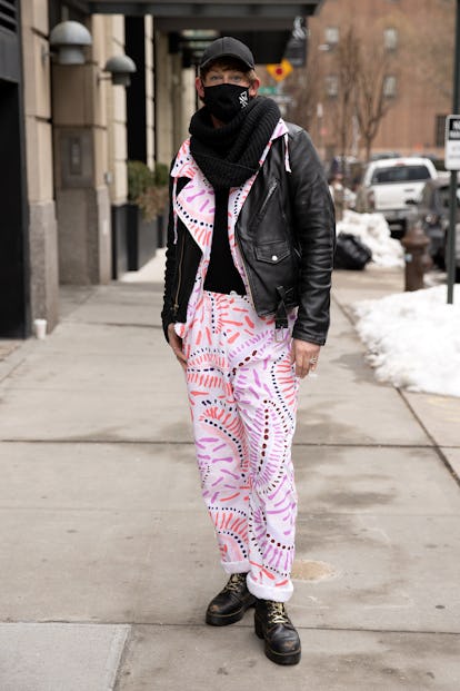 A person poses showing off their abstract printed pants.