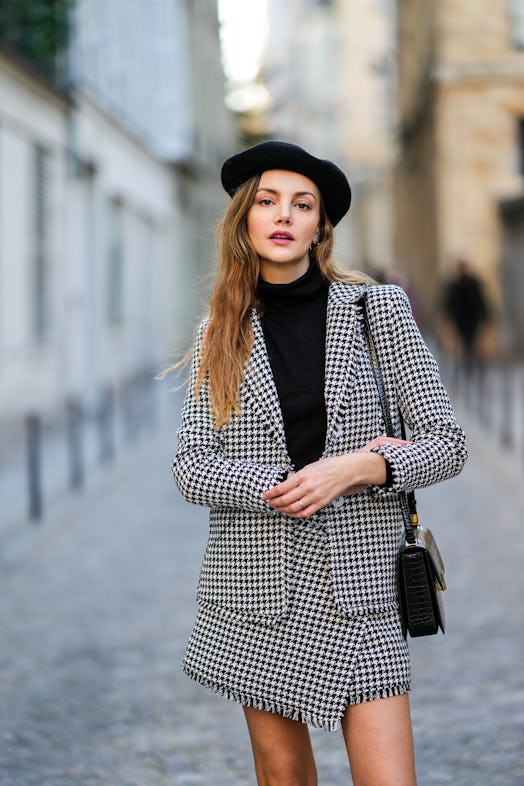 Olesya Senchenko wears a black and white houndstooth print pattern blazer jacket with a matching bla...