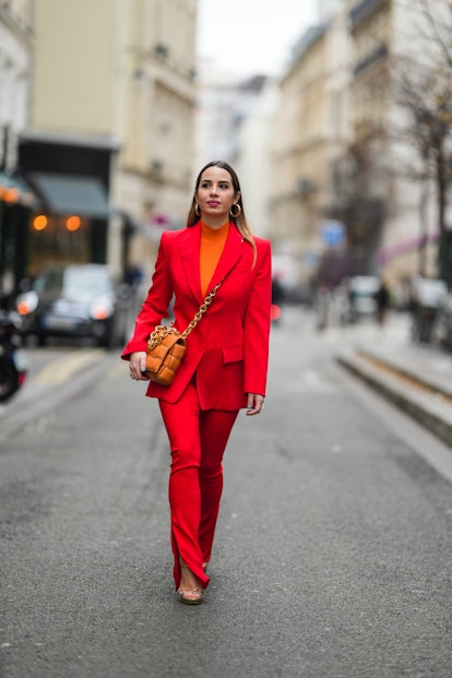 Maria Rosaria Rizzo wore a neon orange ribbed turtleneck pullover, a neon red blazer jacket, matchin...