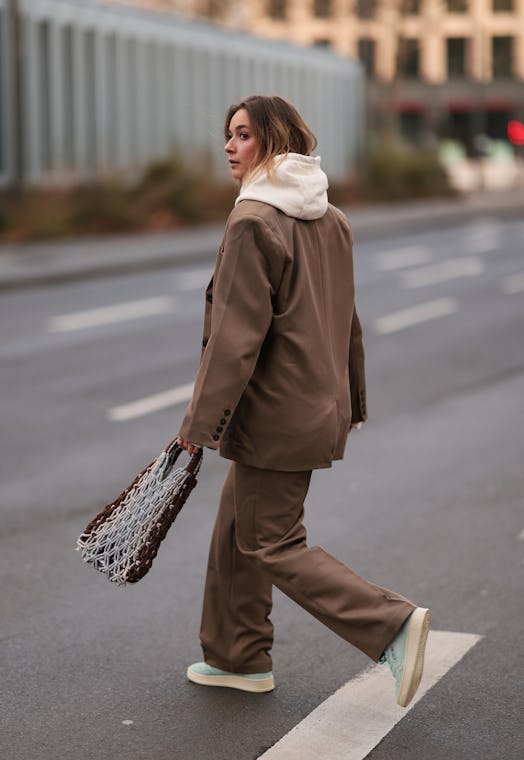 Lisi Rozay wore a Nakd brown suit and Lola beige sweater to create a monochromatic outfit.