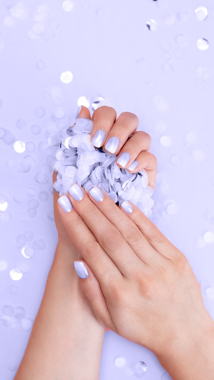 Hands with fresh pink lilac manicure.