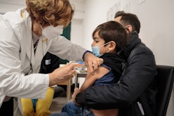 A child receives a dose of the Pfizer Covid-19 vaccine in Pisa, Italy on 18 December 2021. Italy sta...