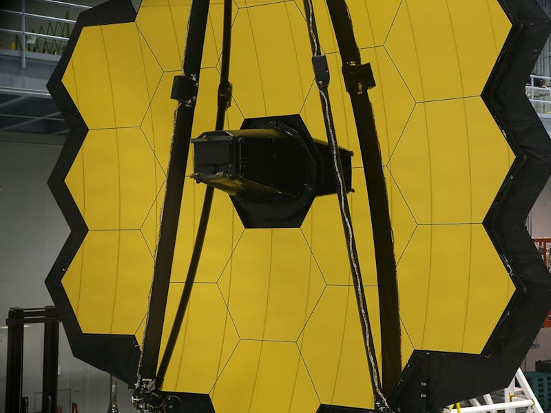 GREENBELT, MD - NOVEMBER 02: A technician stands next to the James Webb Space Telescope during asse...
