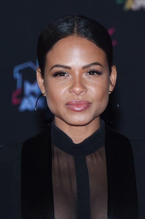 Christina Milian in a sheer black top with a jacket.