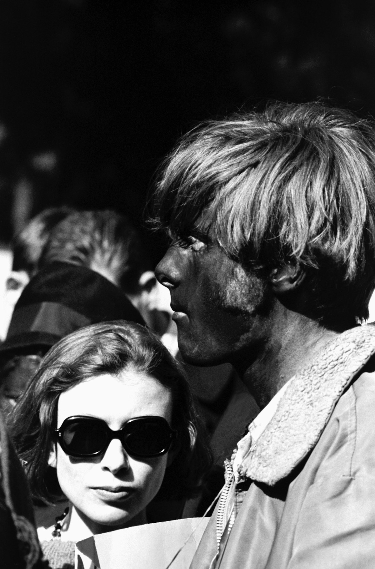 Author Joan Didion stands next to a face-painted hippie at a concert in Golden Gate Park. (Photo by ...