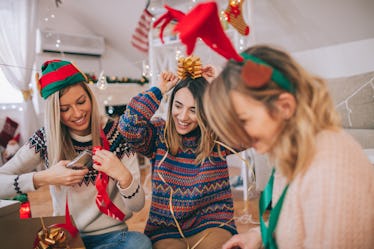 Photo of a couple of friends, wrapping up Christmas presents and thinking of Christmas Instagram cap...