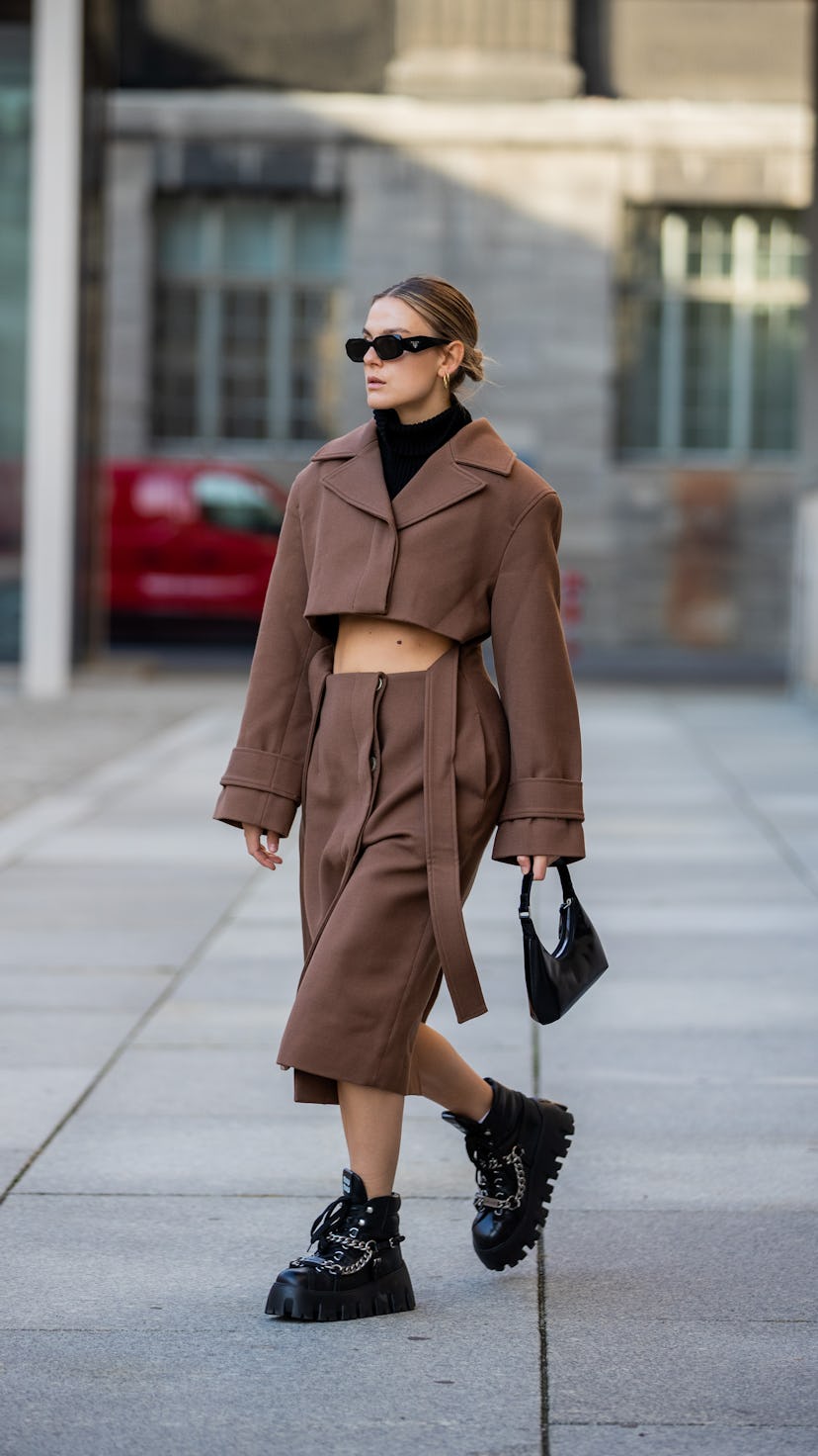 Alessa Winter is seen wearing brown Jacquemus cropped jacket and skirt with winter Miu Miu boots.