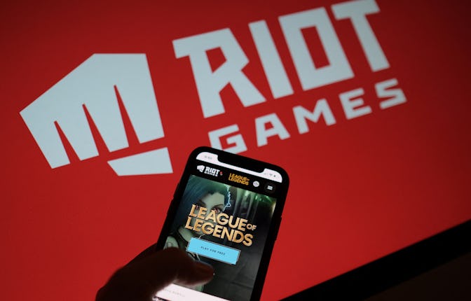 This photo illustration shows a smartphone screen with the game "League of Legends" in front of the ...