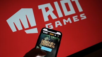 This photo illustration shows a smartphone screen with the game "League of Legends" in front of the ...