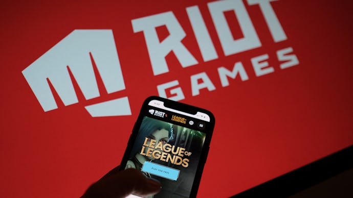 This photo illustration shows a smartphone screen with the game "League of Legends" in front of the ...