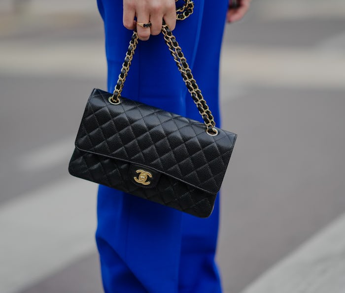 PARIS, FRANCE - NOVEMBER 06: Alice Mouzon wears high waist electric royal blue palazzo pants, a blac...