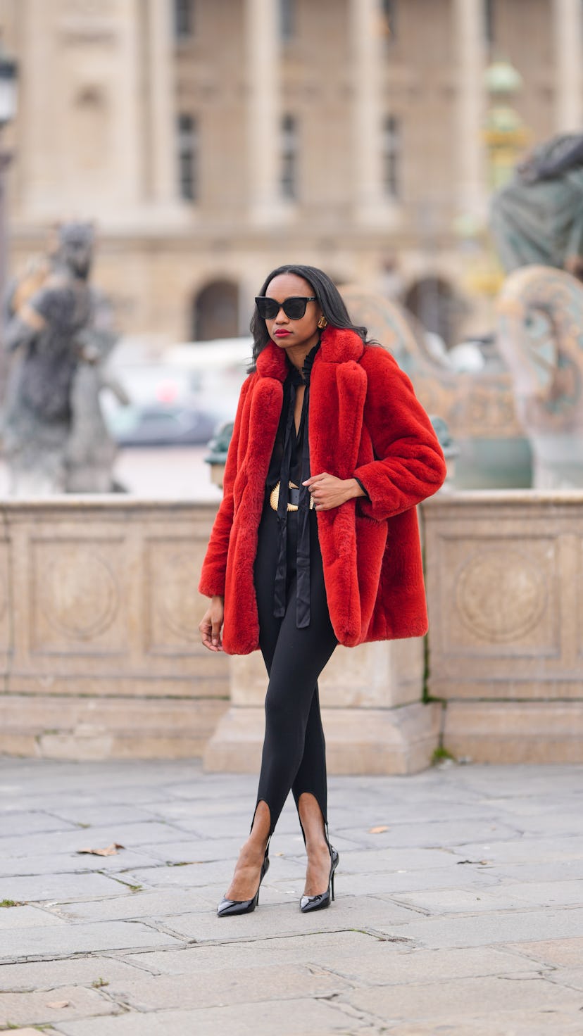 PARIS, FRANCE - DECEMBER 14: Emilie Joseph @in_fashionwetrust wears black sunglasses, gold large ear...