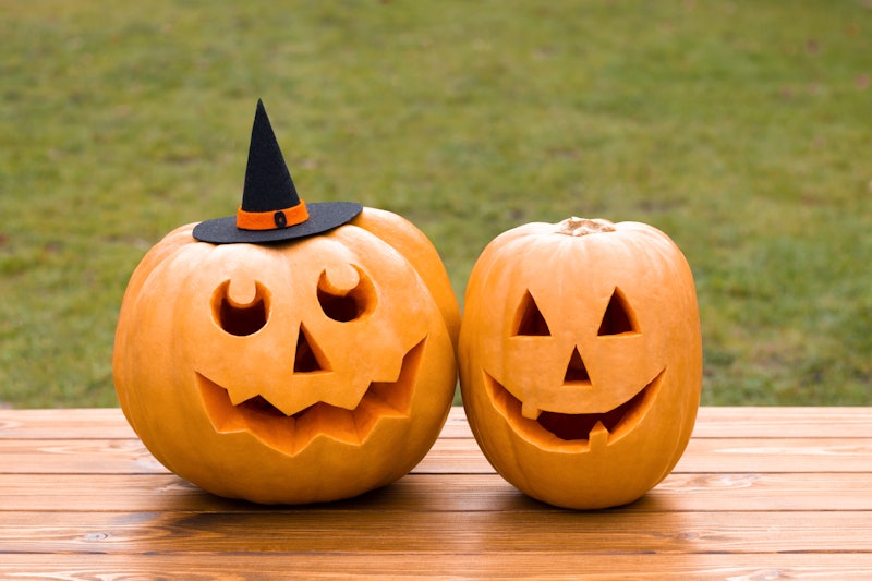 Photo of 2 Halloween carved pumpkins, Jack O'Lantern in witch's hat