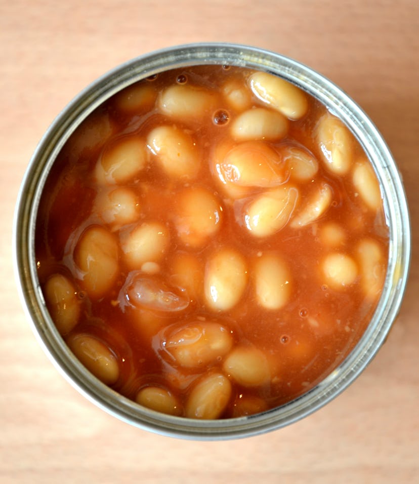 An open tin of baked beans on the kitchen work top.