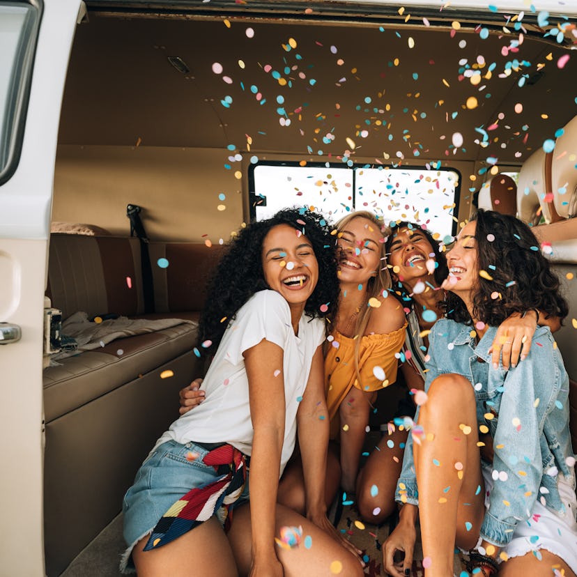 A group of young women celebrating each of their 2022 yearly friendship horoscopes for their zodiac ...