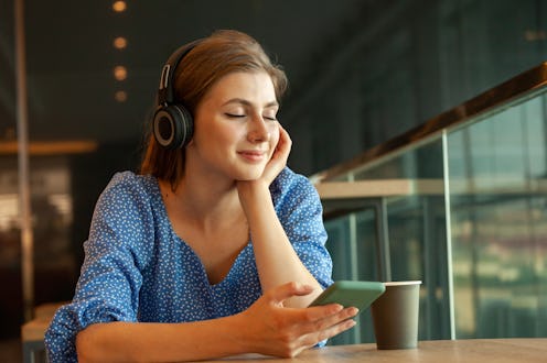 Woman listening to music through her headphones