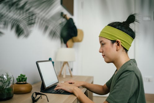 Young asian woman, creative professional or office worker enjoys time at home. Work remotely during ...