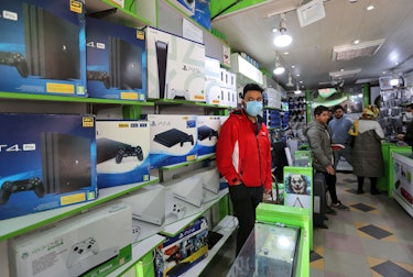 A vendor sells PlayStation 4 (PS4), PS5 and Xbox game consoles at a shop in the central market of Ir...