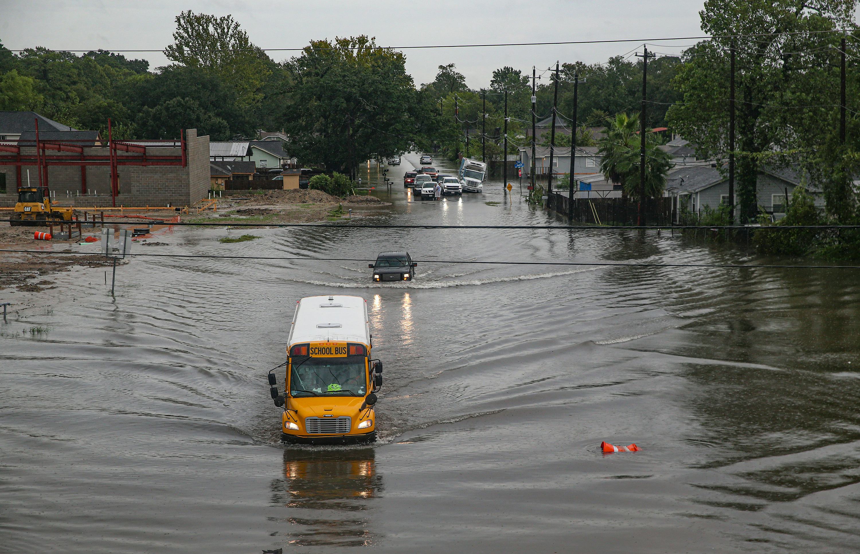 HOUSTON, TX - SEPTEMBER 19: A school bus makes its way on the flooded Hopper Rd. on September 19, 20...