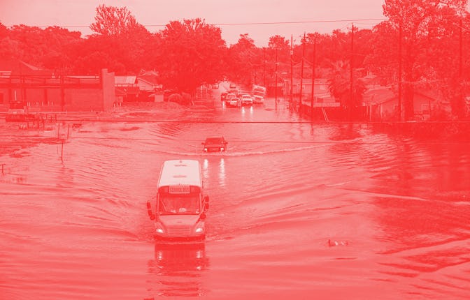 HOUSTON, TX - SEPTEMBER 19: A school bus makes its way on the flooded Hopper Rd. on September 19, 20...