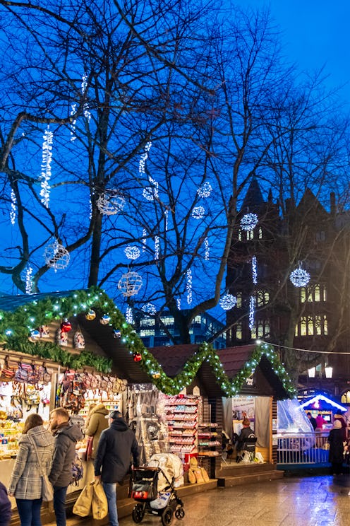 People at the Christmas market at the Belfast City Hall, in the downtown of the capital city of Nort...