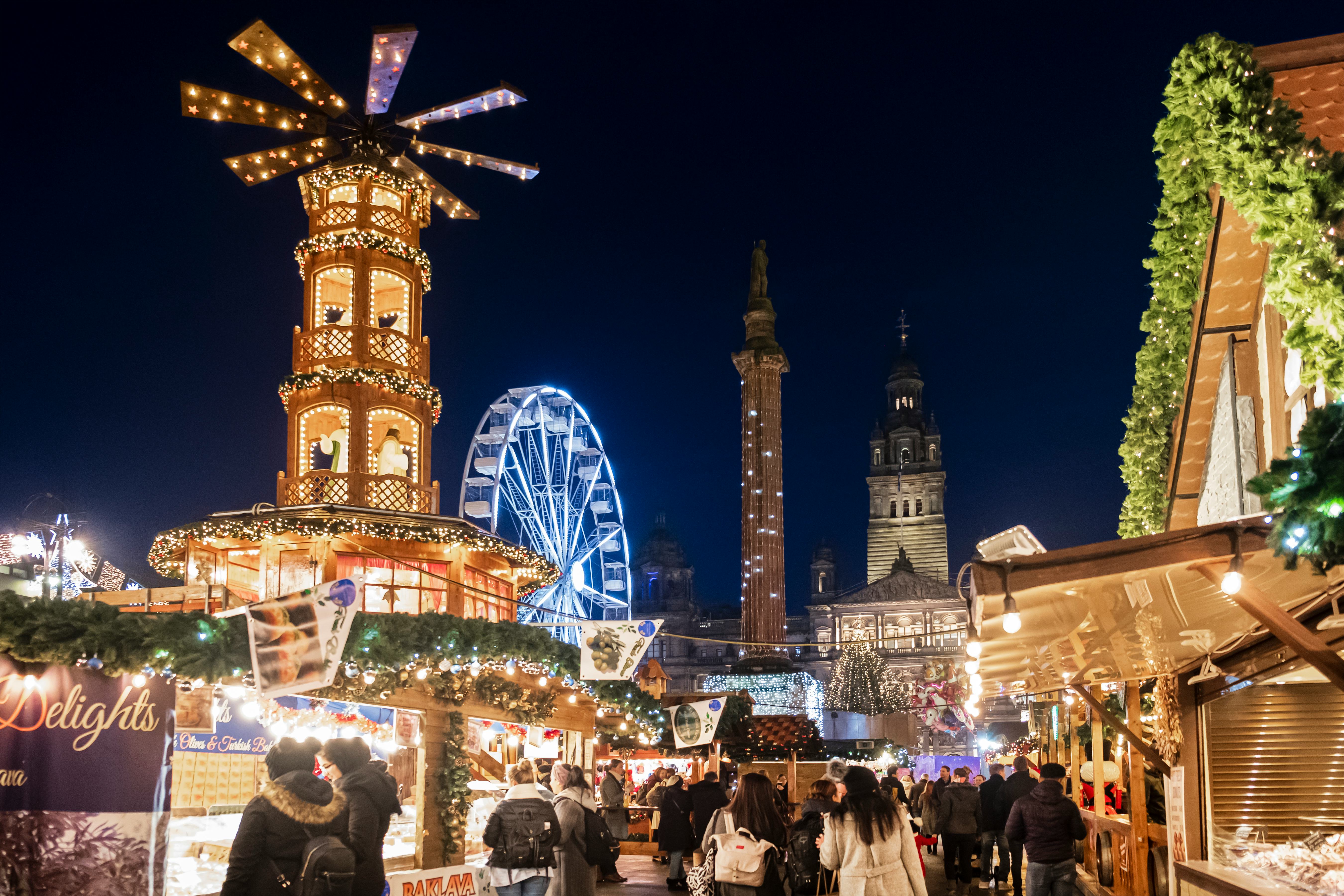 People at the Christmas Market set up in George Square, the principal civic square of Glasgow.