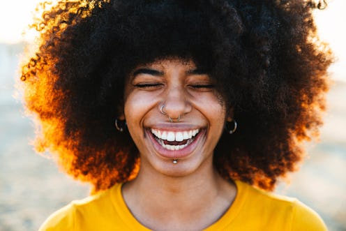 A woman smiles with a close up on her facial piercings. These zodiac signs will be least affected by...