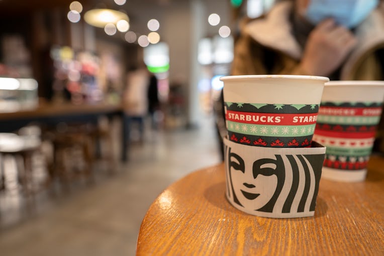 TIANJIN, CHINA - 2020/01/21: Paper coffee cups especially made for Christmas on the table in a Starb...