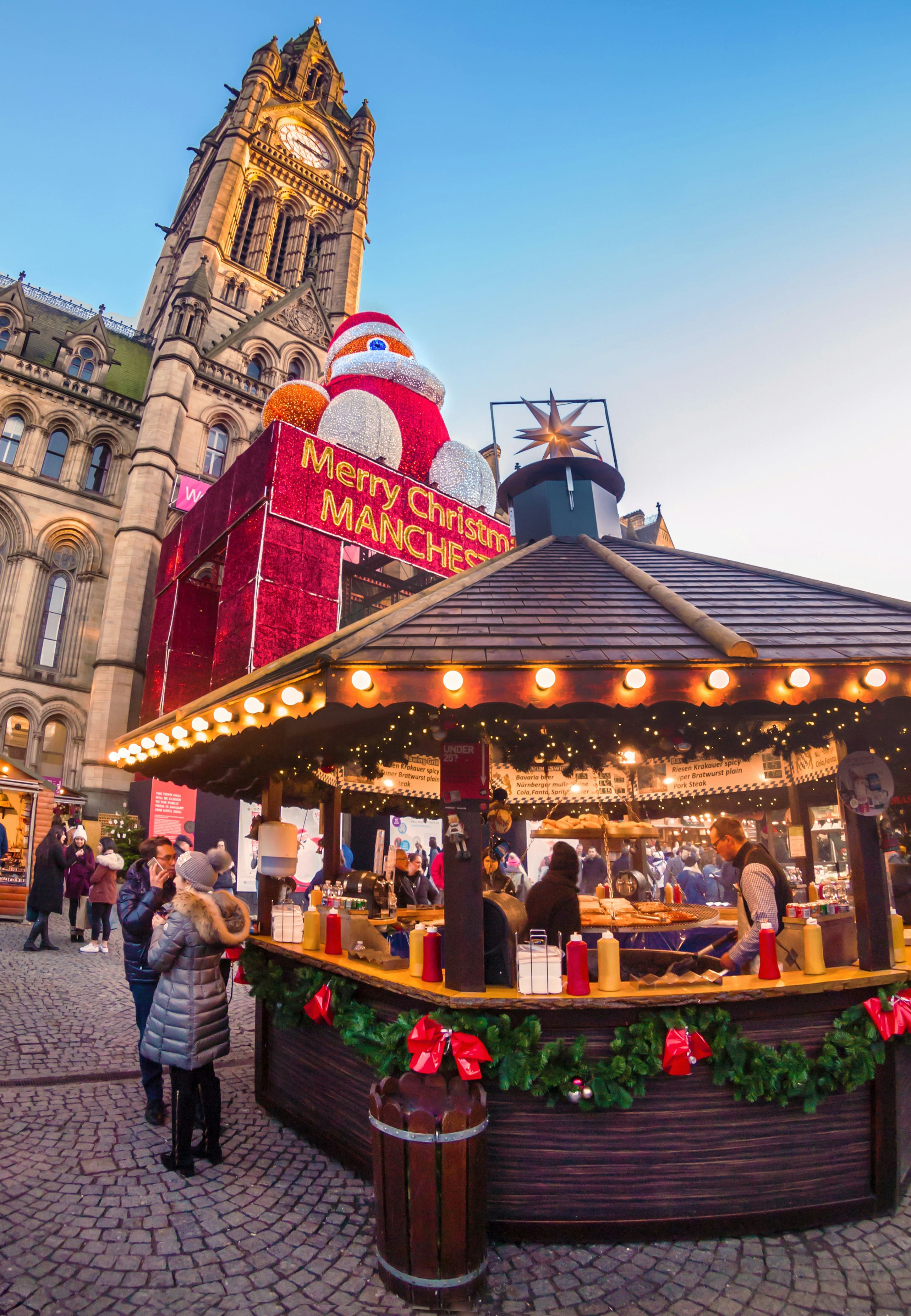 Christmas market placed in Albert square with Manchester Town hall in the background. There is a cou&hellip;