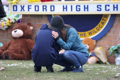 OXFORD, MICHIGAN - DECEMBER 01: People embrace as they visit a makeshift memorial outside of Oxford ...