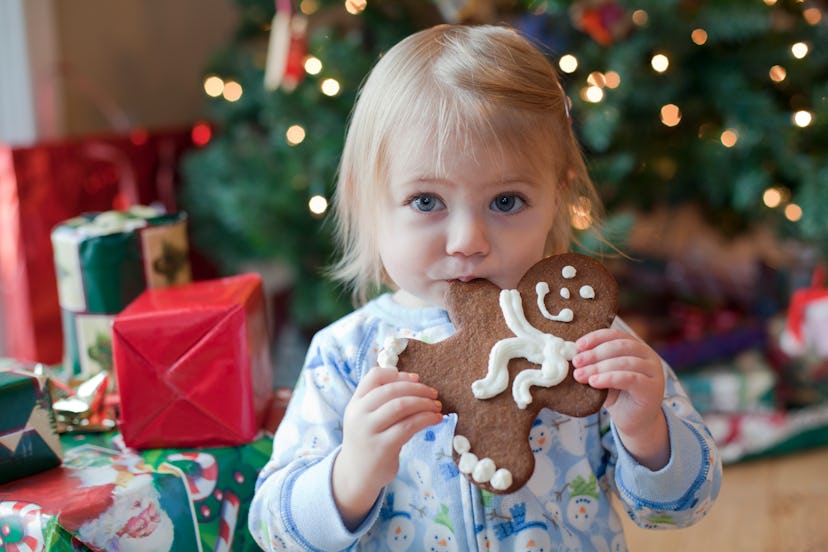 Image of a small child eating a gingerbread cookie.