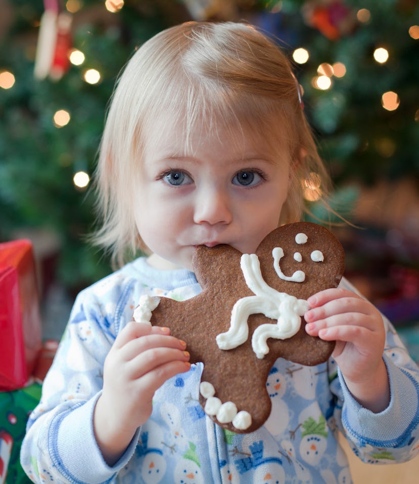 Image of a small child eating a gingerbread cookie.