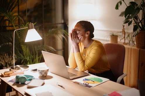 Ambitious and confident businesswomen using laptop computer. Professional people late at night worki...