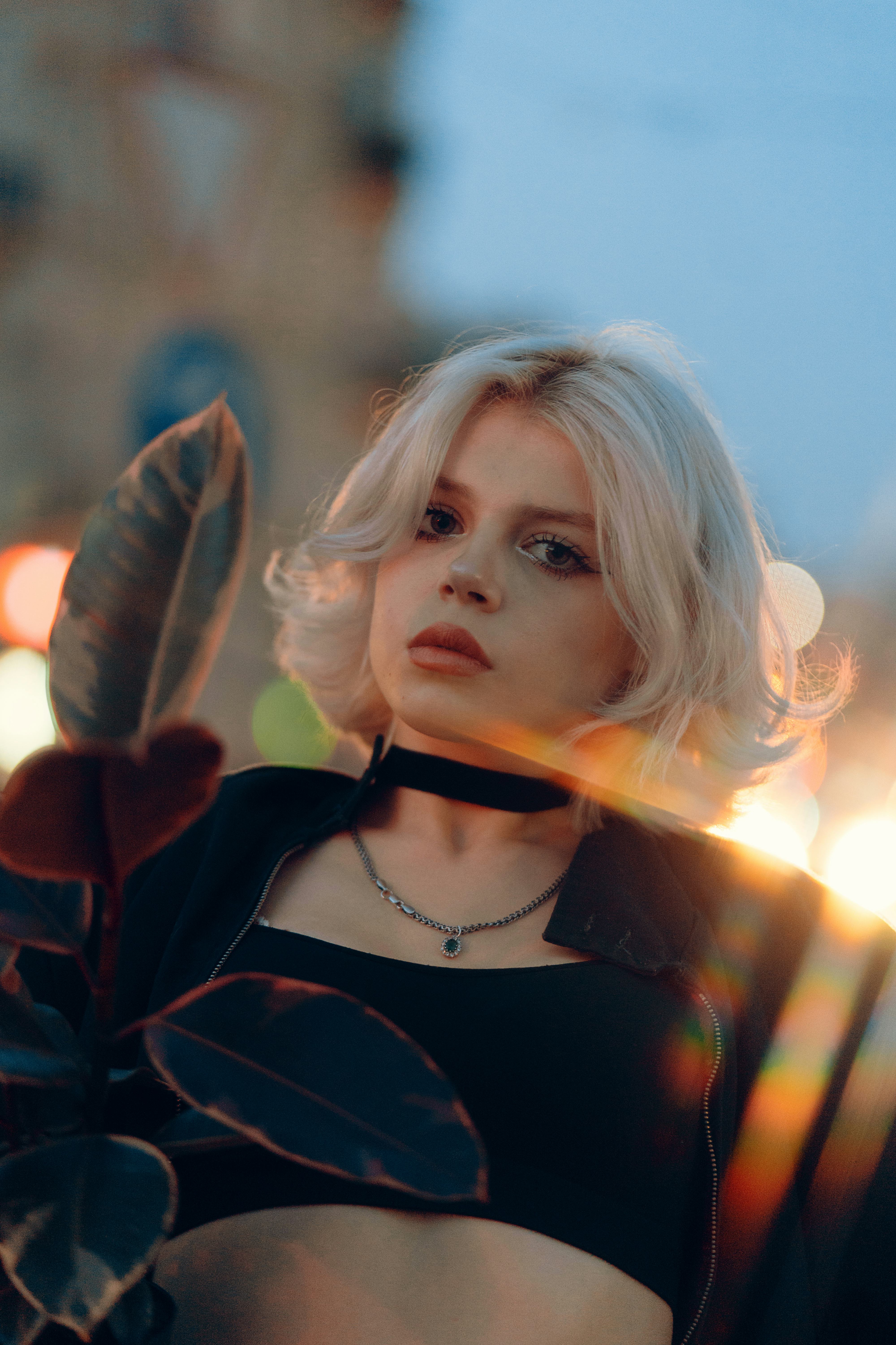 Young woman illuminated by street light, knowing that her zodiac sign experienced the most change du...